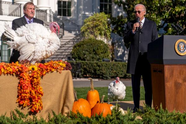 President Joe Biden, accompanied by Ronald Parker, Chairman of the National Turkey Federation, (L), speaks next to Chocolate, the national Thanksgiving turkey, (L), during a pardoning ceremony at the White House, on Nov. 21, 2022. (Andrew Harnik/AP Photo)