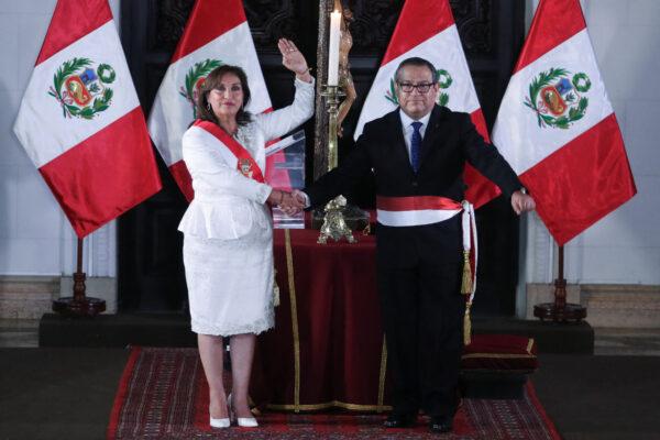 Peru's President Dina Boluarte, who took office after her predecessor, Pedro Castillo, was ousted, stands next to Alberto Otarola, minister of defense, in Lima, Peru, on Dec. 10, 2022. (Sebastian Castaneda/Reuters)