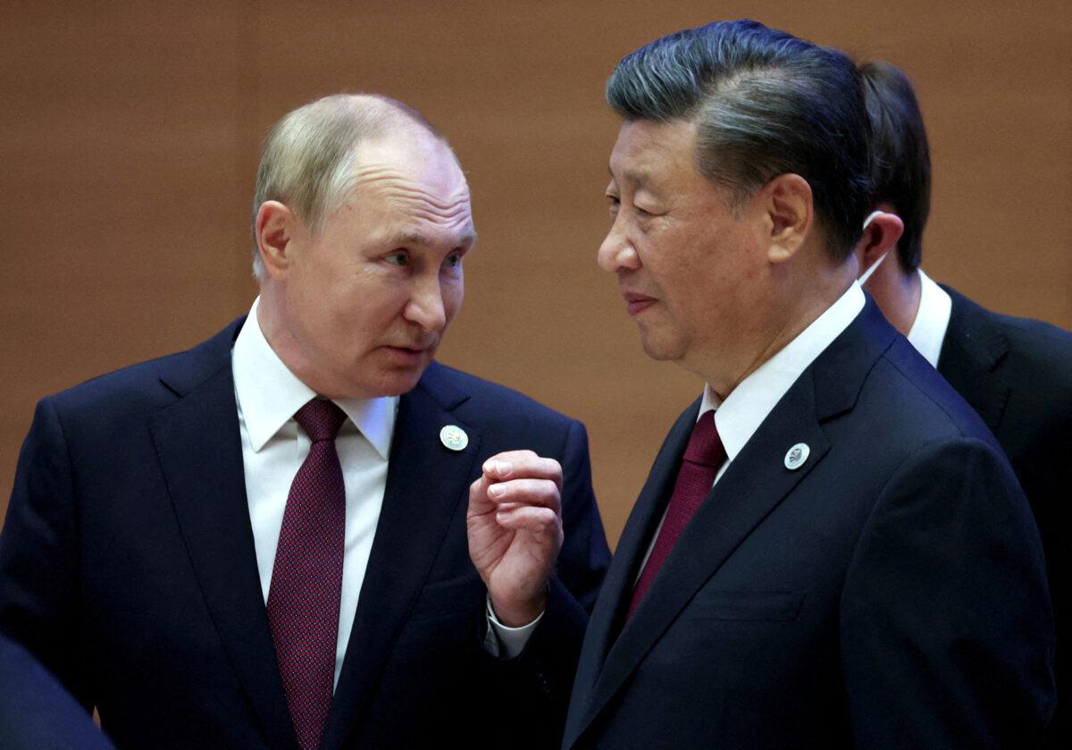 Russian President Vladimir Putin speaks with Chinese leader Xi Jinping before an extended-format meeting of heads of the Shanghai Cooperation Organization summit (SCO) member states in Samarkand, Uzbekistan, on Sept. 16, 2022. (Sputnik/Sergey Bobylev/Pool via Reuters)