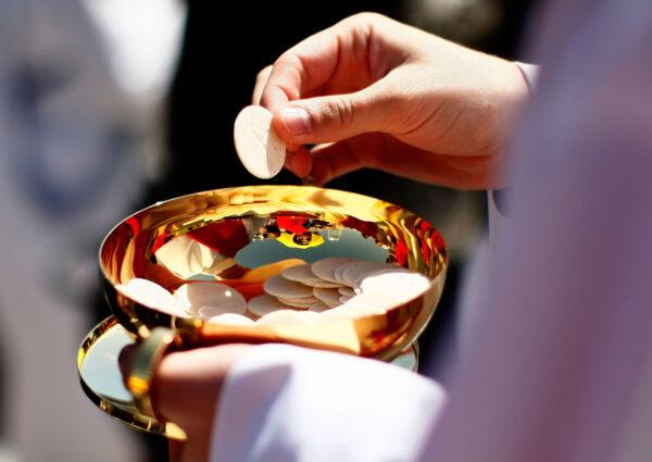 A priest distributes Holy Communion during a Mass celebrated by Pope Benedict XVI at Nationals Park, in Washington, D.C., on April 17, 2008. (Win McNamee/Getty Images)