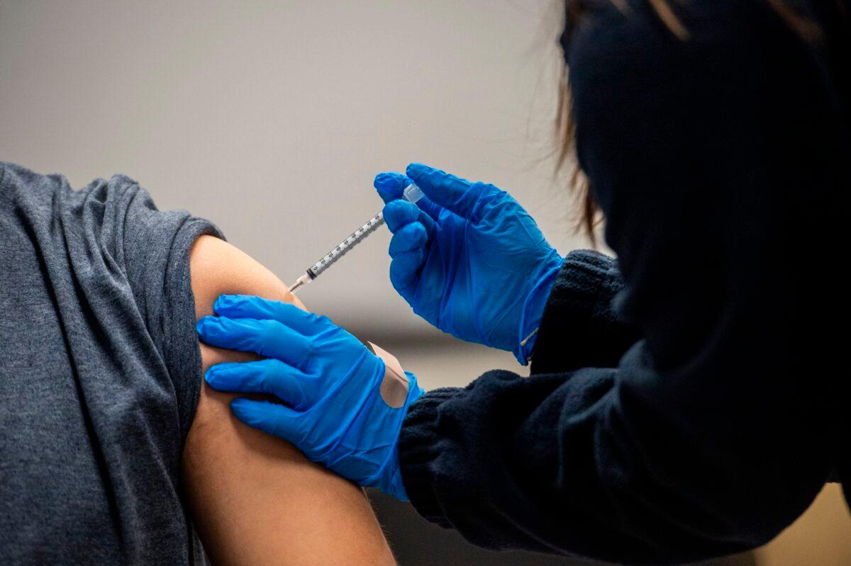 A man is given a COVID-19 vaccine at La Colaborativa in Chelsea, Mass., on Feb. 16, 2021. (Joseph Prezioso/AFP via Getty Images)