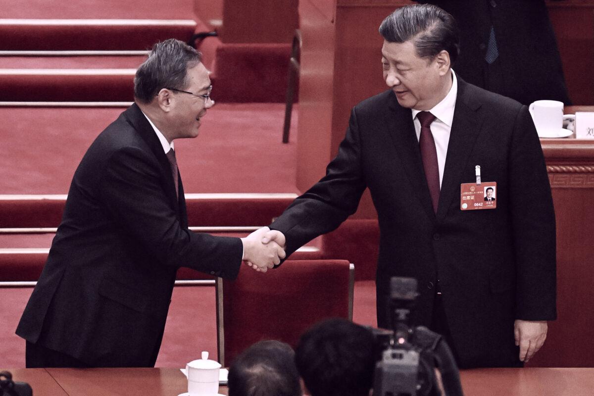 China's leader Xi Jinping (R) is congratulated by Politburo Standing Committee member Li Qiang after being confirmed as the head of the state for a third term during the third plenary session of the National People's Congress (NPC) in Beijing on March 10, 2023. (Noel Celis/AFP via Getty Images)