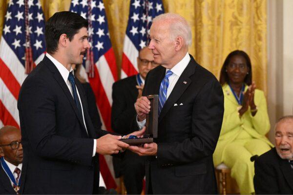 U.S. President Joe Biden posthumously awards the nation's highest civilian honor, the Presidential Medal of Freedom, to Richard Trumka as Richard Trumka Jr. accepts, during a ceremony honoring 17 recipients, in the East Room of the White House in Washington on July 7, 2022. (Saul Loeb/AFP via Getty Images)