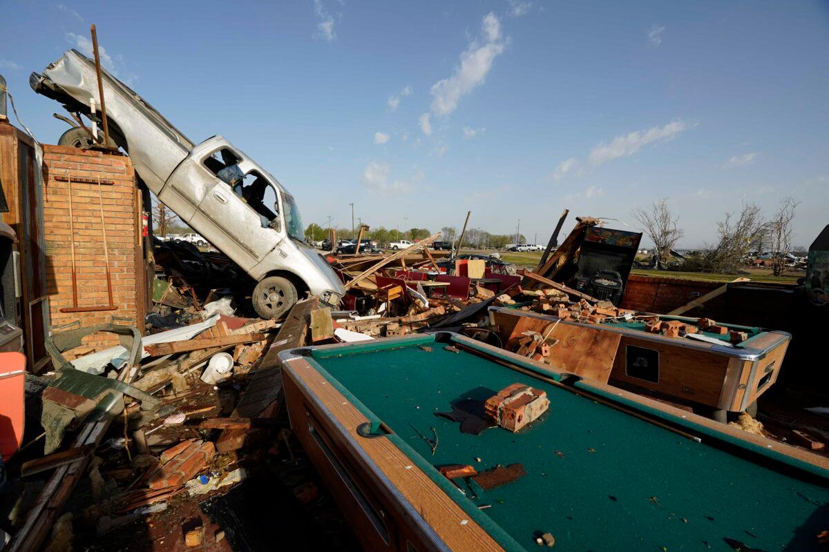 Wind-tossed vehicles, are piled onto another in Rolling Fork, Miss., on March 25, 2023. (Rogelio V. Solis/AP Photo)