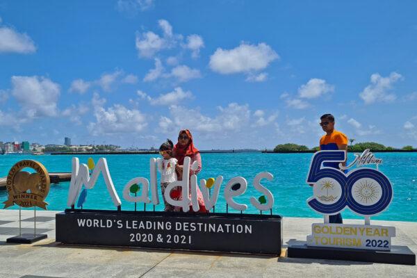 Tourists pose for pictures at the Velana International Airport in the Maldives on July 14, 2022. (AFP via Getty Images)