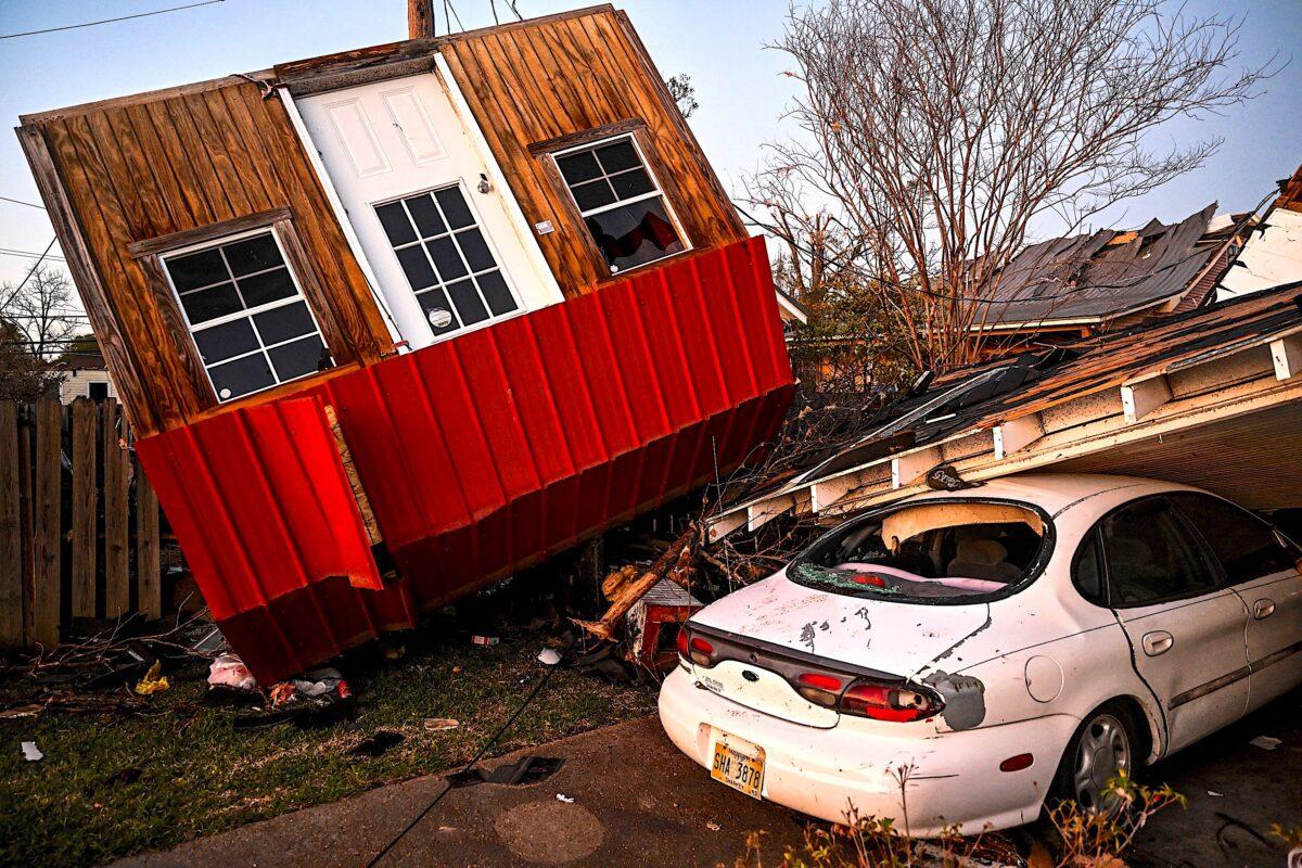 The remains of a crushed house and cars in Rolling Fork, Miss., on March 25, 2023, after a tornado touched down in the area. (Chandan Khanna/AFP via Getty Images)
