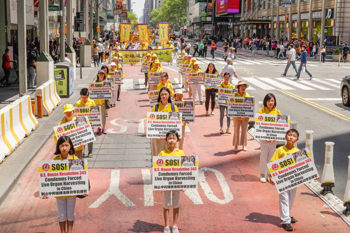 Falun Gong practitioners march in Manhattan to celebrate World Falun Dafa Day, in New York, on May 12, 2023. (Larry Dye/The Epoch Times)
