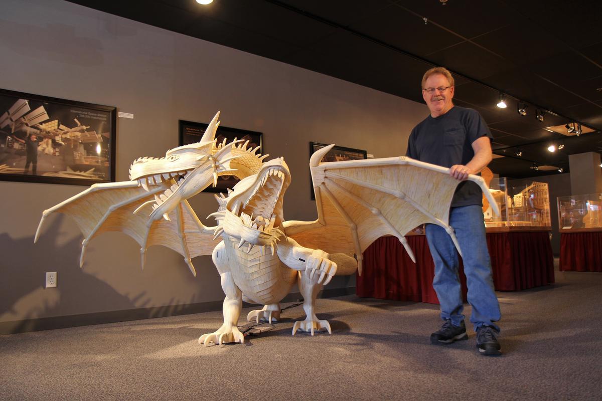 Acton poses beside a model two-headed dragon made of 272,000 matchsticks, completed in 2016. (Courtesy of Patrick Acton)
