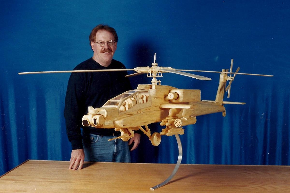 Acton poses with his model Apache attack helicopter, made of 26,000 matchsticks, completed in 2004. (Courtesy of Patrick Acton)