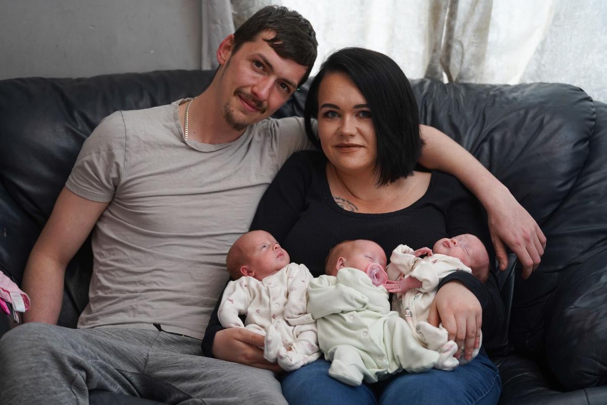 James Casper, 26, and Jenni Casper 27, with their newly born triplets, Evalynn, Harper-Gwen, and Marvella. (SWNS)