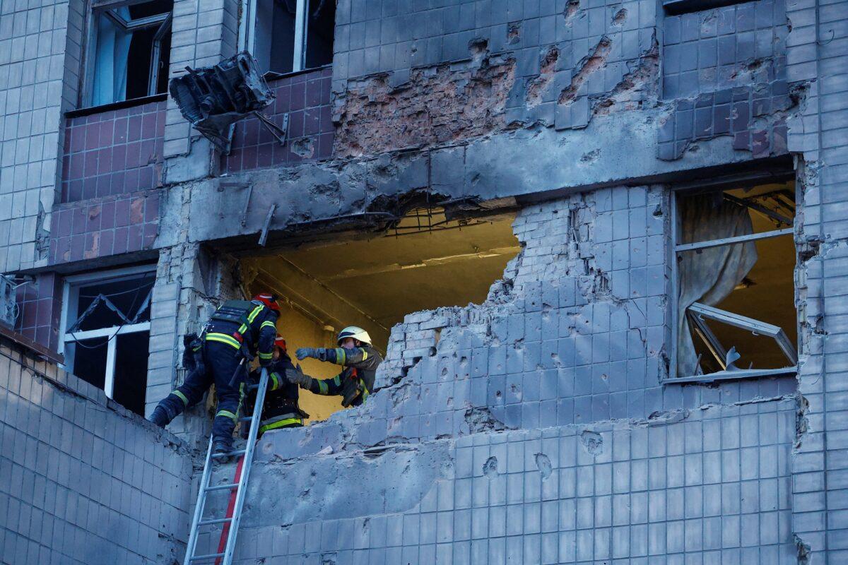 Rescuers work at a site of a building damaged during a Russian suicide drone strike in Kyiv, Ukraine, on May 28, 2023. (Valentyn Ogirenko/Reuters)
