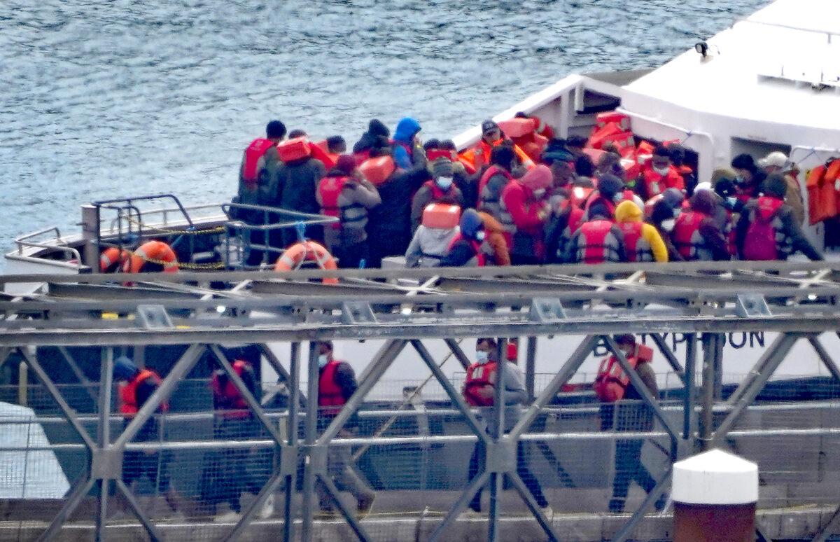 A group of illegal immigrants are brought by a Border Force vessel to Dover, Kent, on May 19, 2023. (Gareth Fuller/PA Media)
