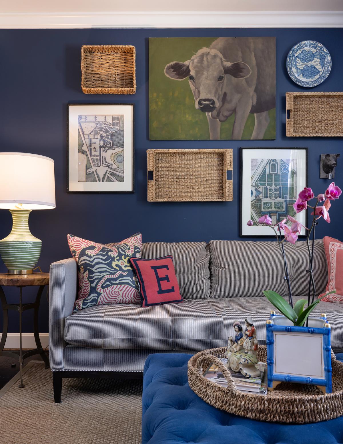 The sitting room's walls are dressed in a rich navy that complements the buttery velvet ottoman in the middle of the room and sets the tone for a bold and vibrant space that still brings an air of relaxation. (Handout/TNS)