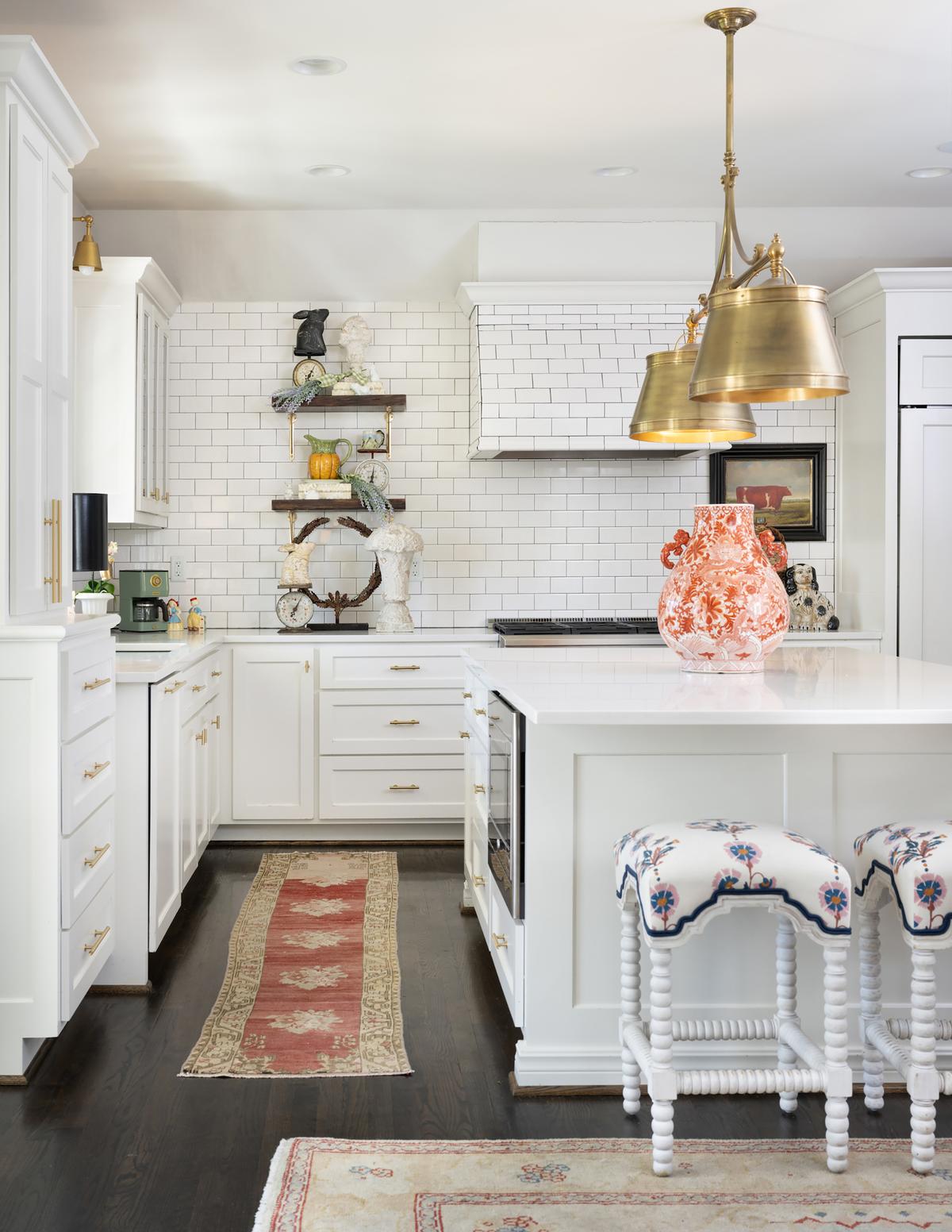 Anne lives for preppy chinoiserie, so a burnt orange vase makes perfect sense as the focal point of her kitchen island. Above it, she added brushed brass pendant lights. (Handout/TNS)