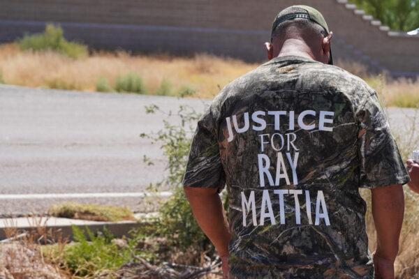 A man wears a "Justice For Ray Mattia" camouflage shirt during a rally outside of the U.S. Customs and Border Patrol station in Why, Ariz., on May 27, 2023. (Allan Stein/The Epoch Times)