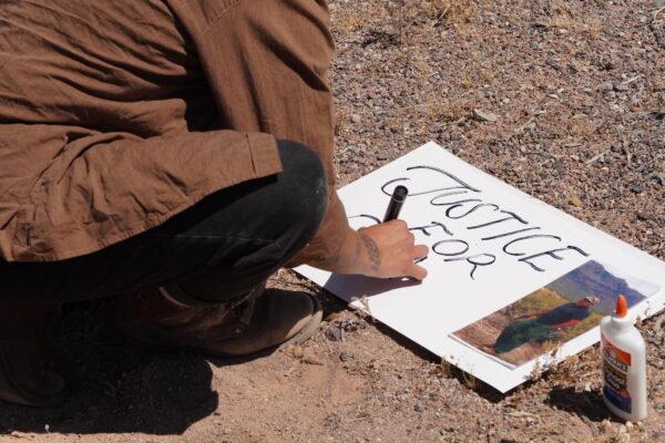 A protester makes a sign in support of shooting victim Raymond Mattia during a protest in Why, Ariz., on May 27, 2023. (Allan Stein/The Epoch Times)