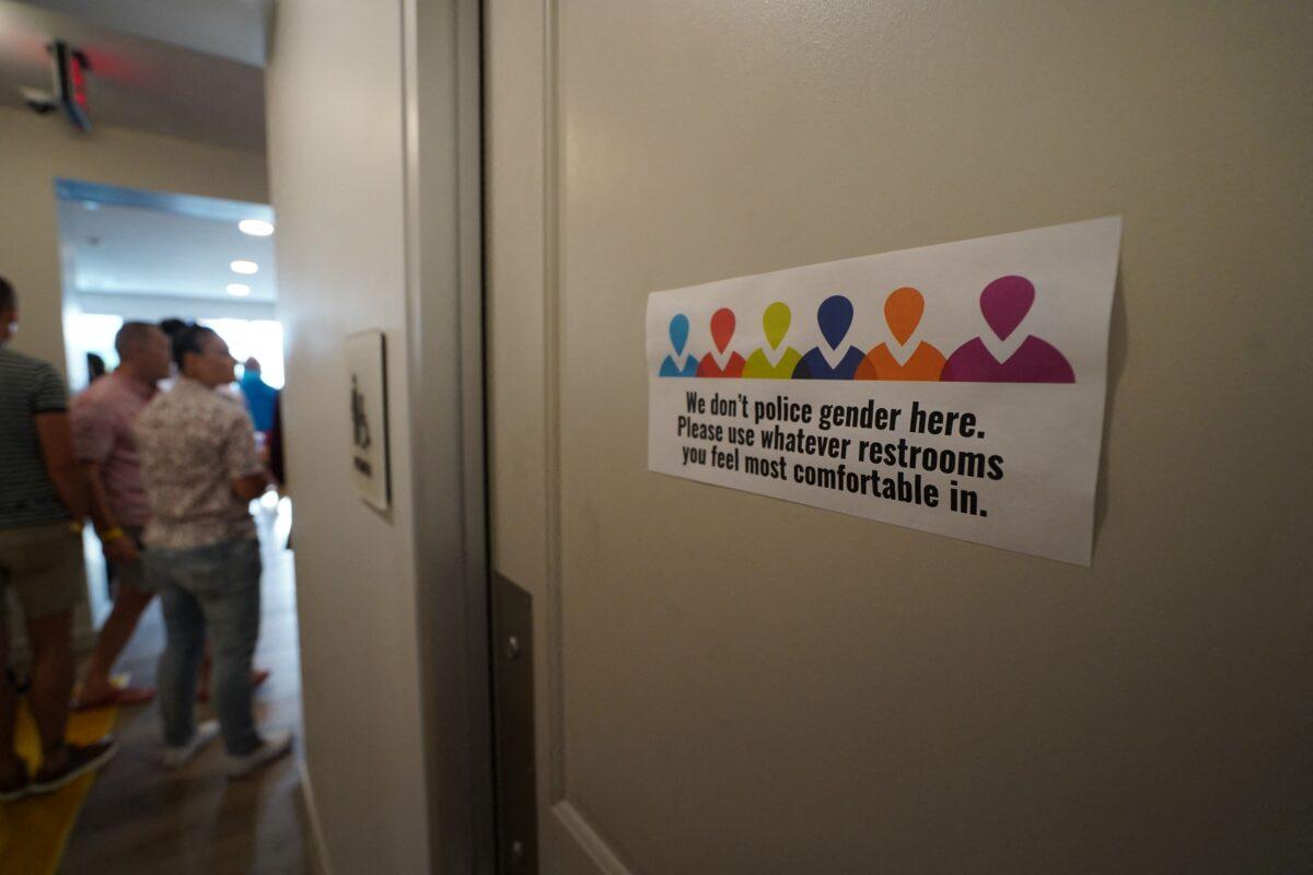 A bathroom sign is seen during the opening of the Law Harrington Senior Living Center, the largest LGBT senior apartment residence in the United States, in Houston on June 24, 2021. (Francois Picard/AFP via Getty Images)