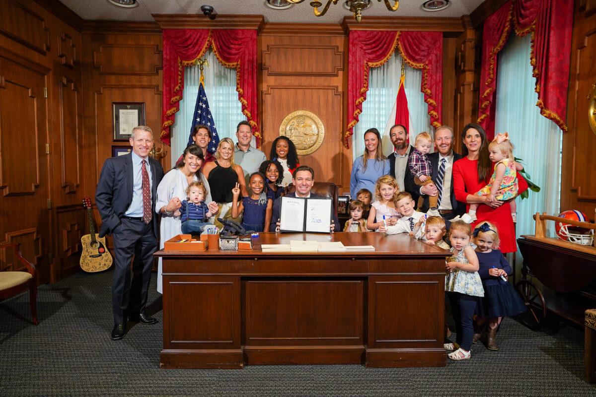 Florida Gov. Ron DeSantis signs a family tax relief bill in his Tallahassee office on May 25, 2023. (Courtesy of the Florida Governor's Office.)