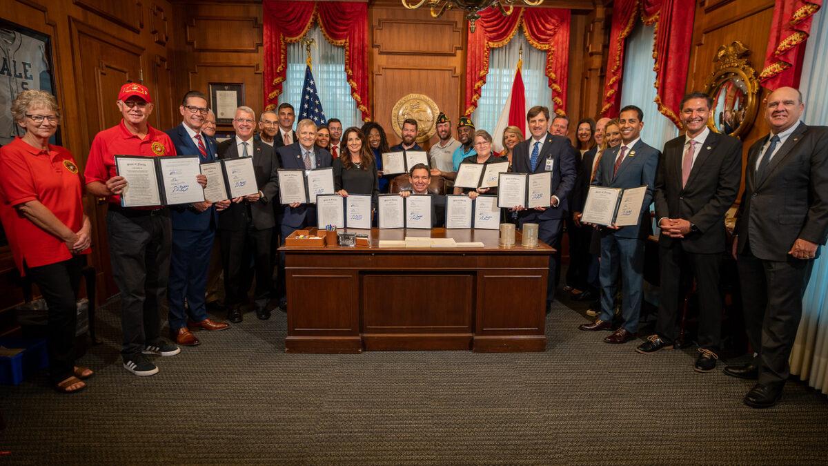 Florida Gov. Ron DeSantis signs bills supporting veterans, service members, and their families on May 26, 2023. (Courtesy of the Florida Governor's Office.)