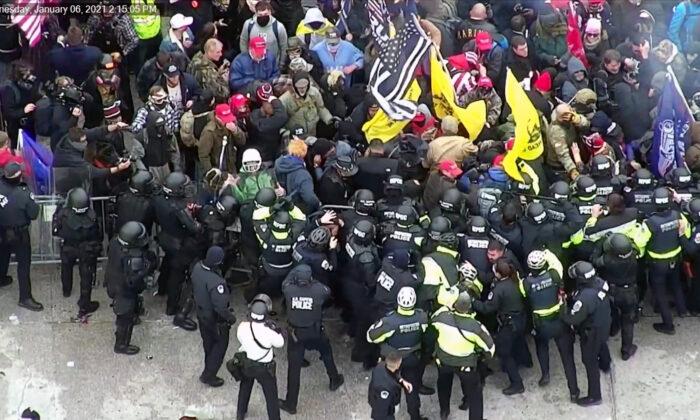 Protesters clash with police on the west front of the U.S. Capitol on Jan. 6, 2021, as shown on a CCTV exterior Rotunda camera. (U.S. Capitol Police/Screenshot via The Epoch Times)