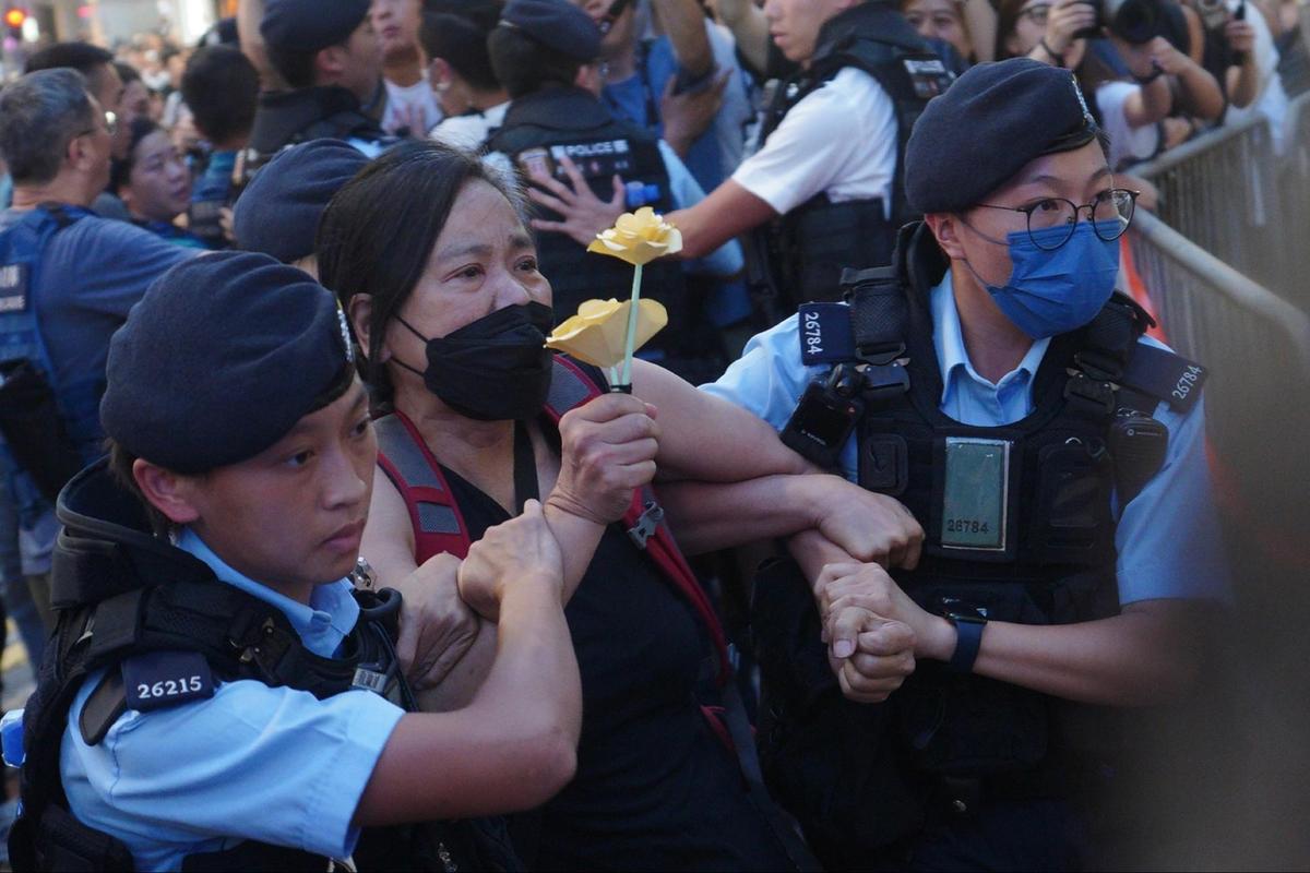 Chan Po-ying, chairman of the League of Social Democrats, was taken away by the police in Hong Kong on June 4, 2023. (Benson Lau/ The Epoch Times)