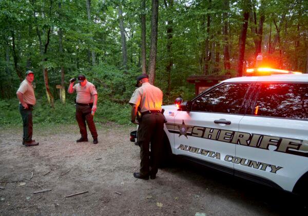Authorities secure the entrance to Mine Bank Trail, an access point to the rescue operation along the Blue Ridge Parkway where a Cessna Citation crashed over mountainous terrain near Montebello, Va., on June 4, 2023. (Randall K. Wolf via AP)