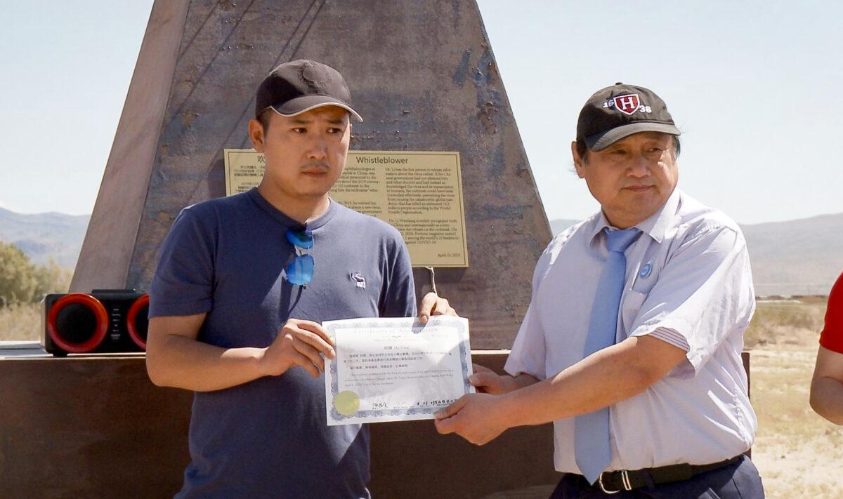 Hu Yang receives a certificate from the China Democracy Party in recognition of his volunteer work, at Liberty Sculpture Park, in Yermo, Calif., on April 23, 2023. (Courtesy of Hu Yang)