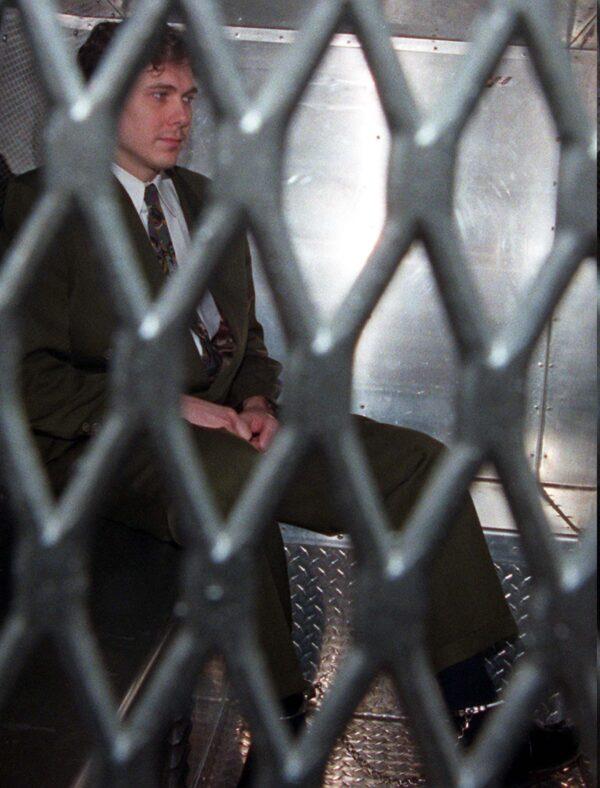 Paul Bernardo arrives at the provincial courthouse in Toronto on November 3, 1995. The convicted murderer arrived in the back of a police van wearing handcuffs and leg irons. (The Canadian Press/Frank Gunn)