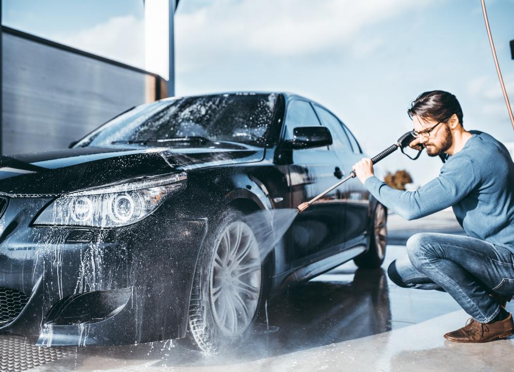 If you can’t wash the car at home, consider the local coin-operated car wash, using your own sponges or wash mitts to clean the exterior. (hedgehog94/Shutterstock)