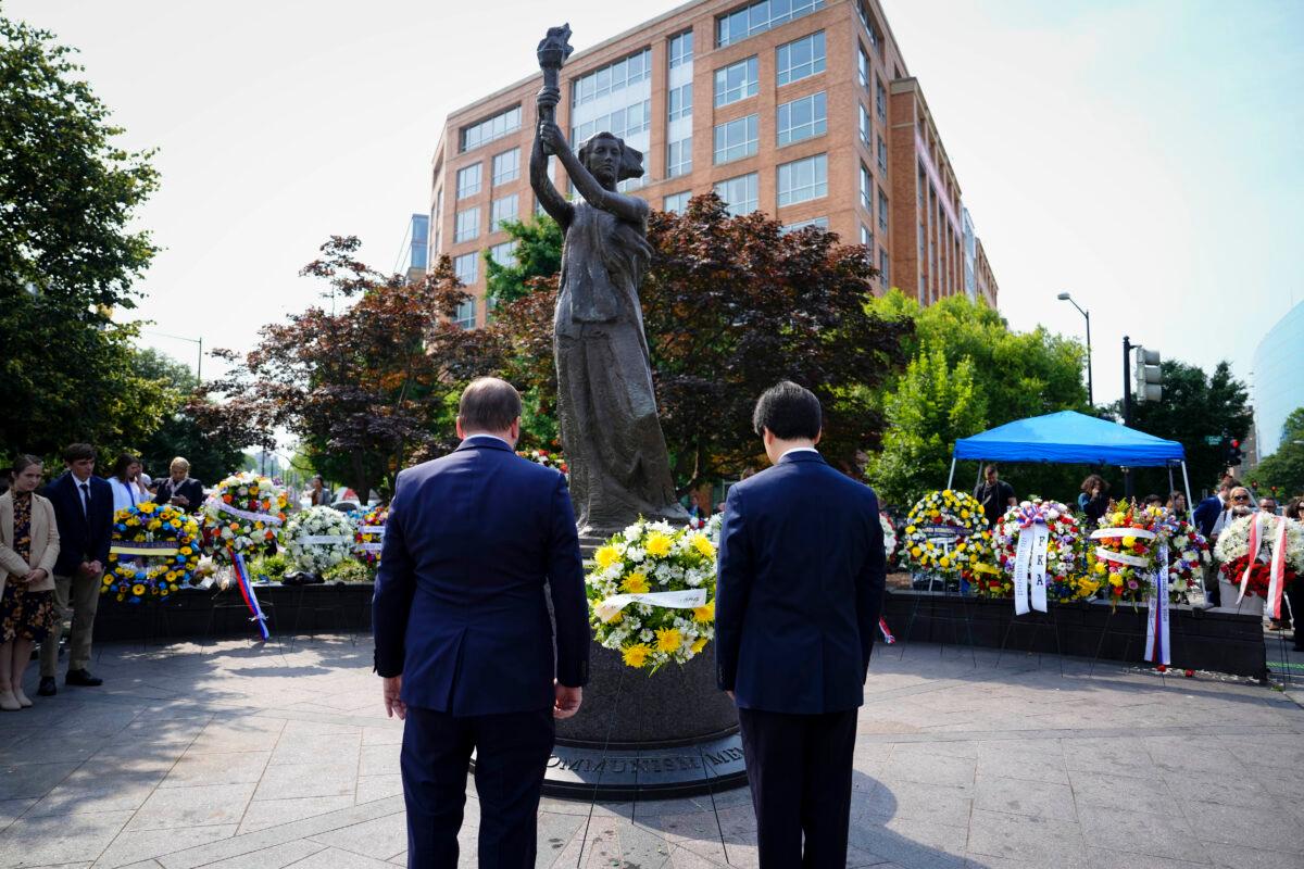 Friends of Falun Gong representatives Erik Meltzer (L) and Mark Yang (R) attend the 16th annual roll call of nations wreath-laying ceremony convened with embassies, representatives of captive nations, and human rights organizations at the Victims of Communism Memorial in Washington on June 9, 2023. (Madalina Vasiliu/The Epoch Times)