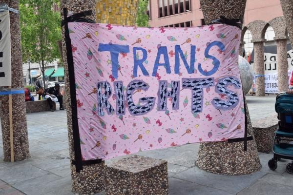 Sign supporting transgender individuals hangs on a street corner in Philadelphia on July 1, 2023. (Beth Brelje/Epoch Times)