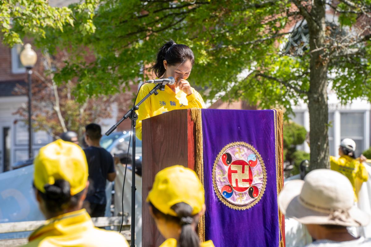 Lydia Wang shed tears during her speech at a rally calling for an end to the persecution of Falun Gong in China in Goshen, N.Y., on July 22, 2023. (Cara Ding/The Epoch Times)