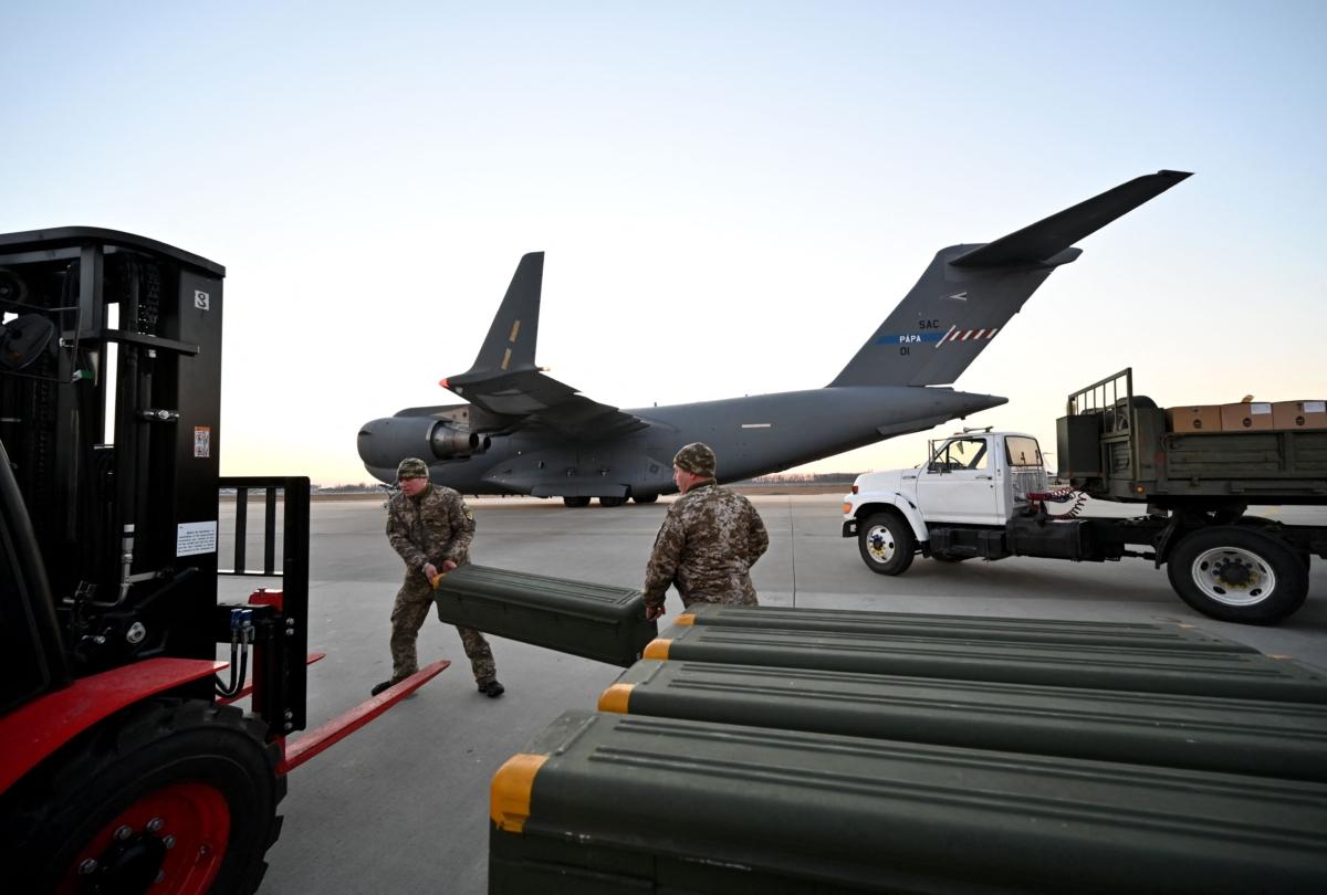 Servicemen of Ukrainian Military Forces move U.S. made FIM-92 Stinger missiles, a man-portable air-defence system (MANPADS), that operates as an infrared homing surface-to-air missile (SAM), and the other military assistance shipped from Lithuania to Boryspil Airport in Kyiv, Ukraine, on Feb. 13, 2022. (Sergei Supinsky/AFP via Getty Images)