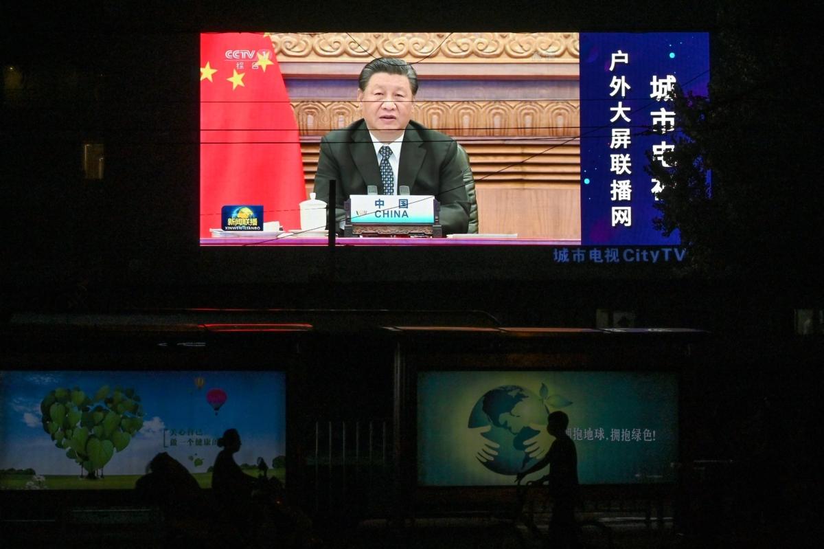 A large screen shows a news programme featuring Chinese President Xi Jinping speaking via video at the opening of the virtual BRICS Summit being hosted by India, on a street in Beijing on Sept. 10, 2021. (Greg Baker/AFP via Getty Images)
