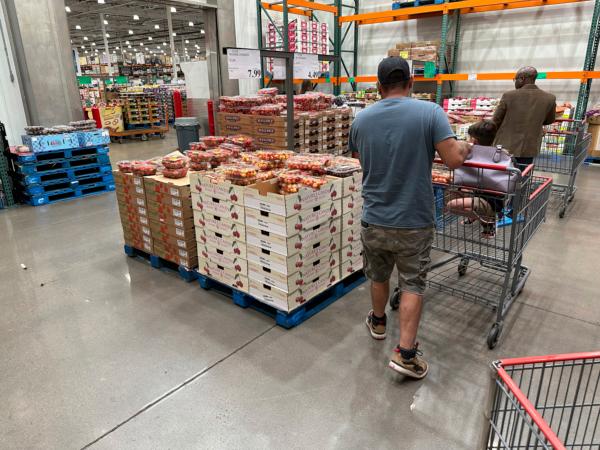 Shoppers peruse a display of cherries at a Costco warehouse in Sheridan, Colo., on July 11, 2023. (David Zalubowski/AP Photo)