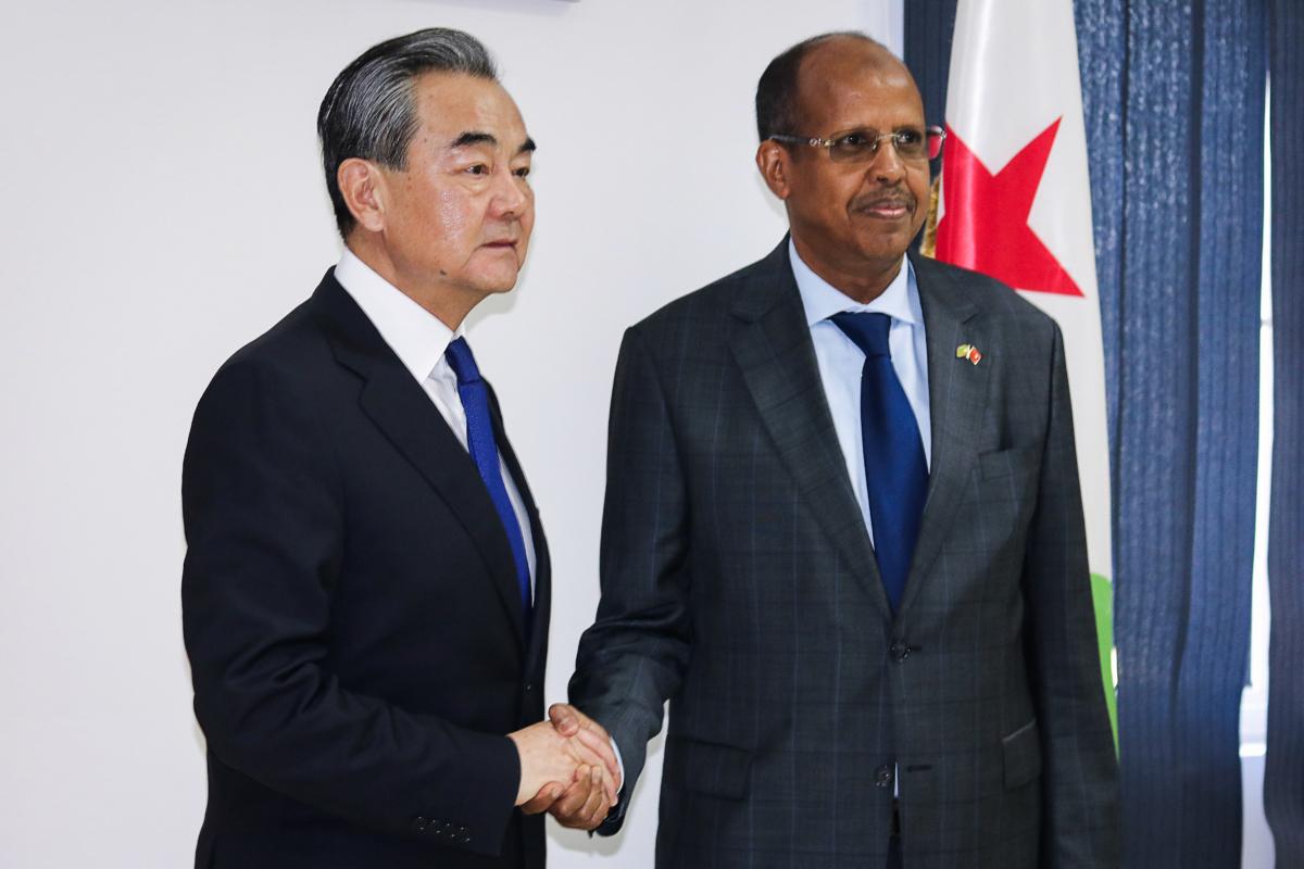 Chinese Foreign Minister Wang Yi shakes hands with Djibouti's Minister of Foreign Affairs and International Cooperation Mahamoud Ali Youssouf upon his arrival at the diplomatic institute in Djibouti, on Jan. 9, 2020. (-/AFP via Getty Images)