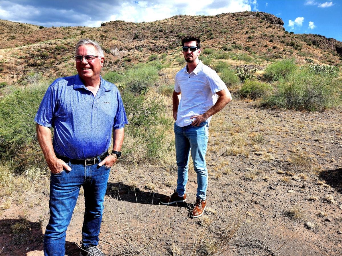 Timothy Hyland, co-owner of Silver Mountain Ranches in Mayer, Ariz., and solar power expert George Soucek of Sunbear Industries stand at ground zero of a 40-unit off-grid housing development in Mayer, Ariz., on Aug. 2, 2023. (Allan Stein/The Epoch Times)