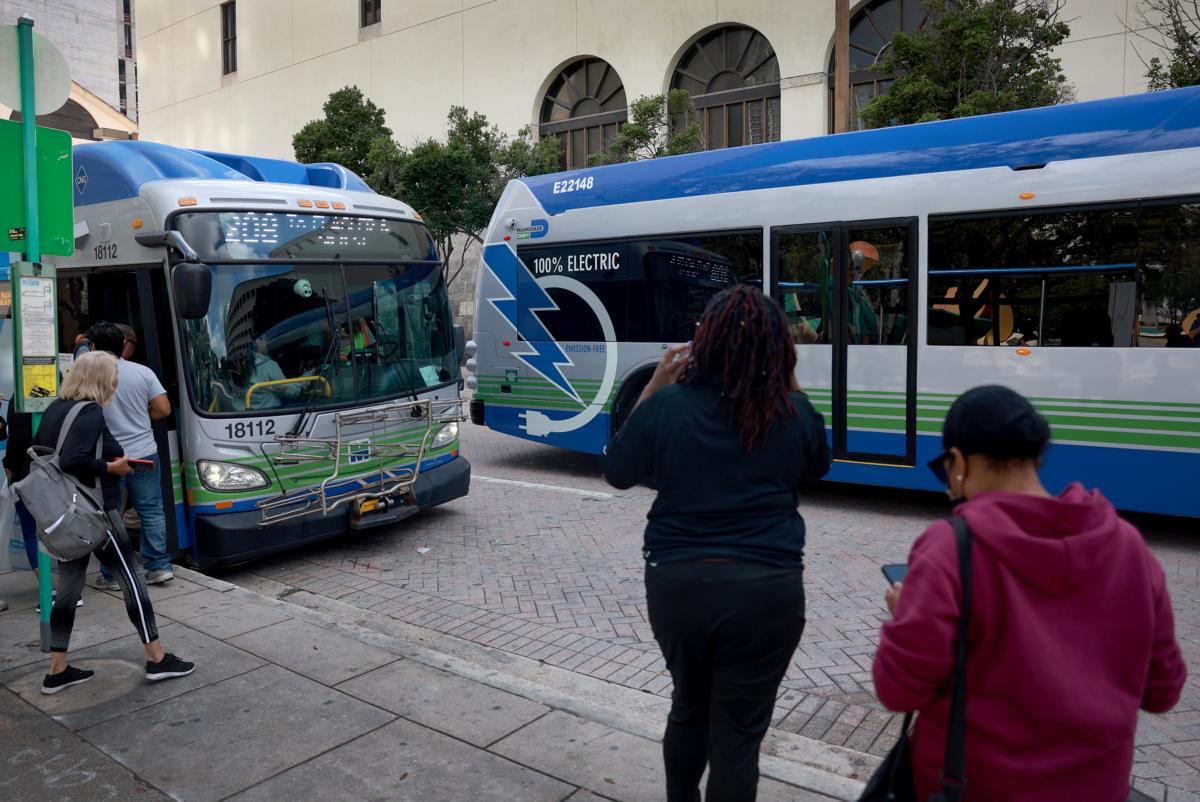 A battery-powered electric bus made by Proterra drives past a bus stop in Miami, Fla., on Feb. 2, 2023. (Joe Raedle/Getty Images)