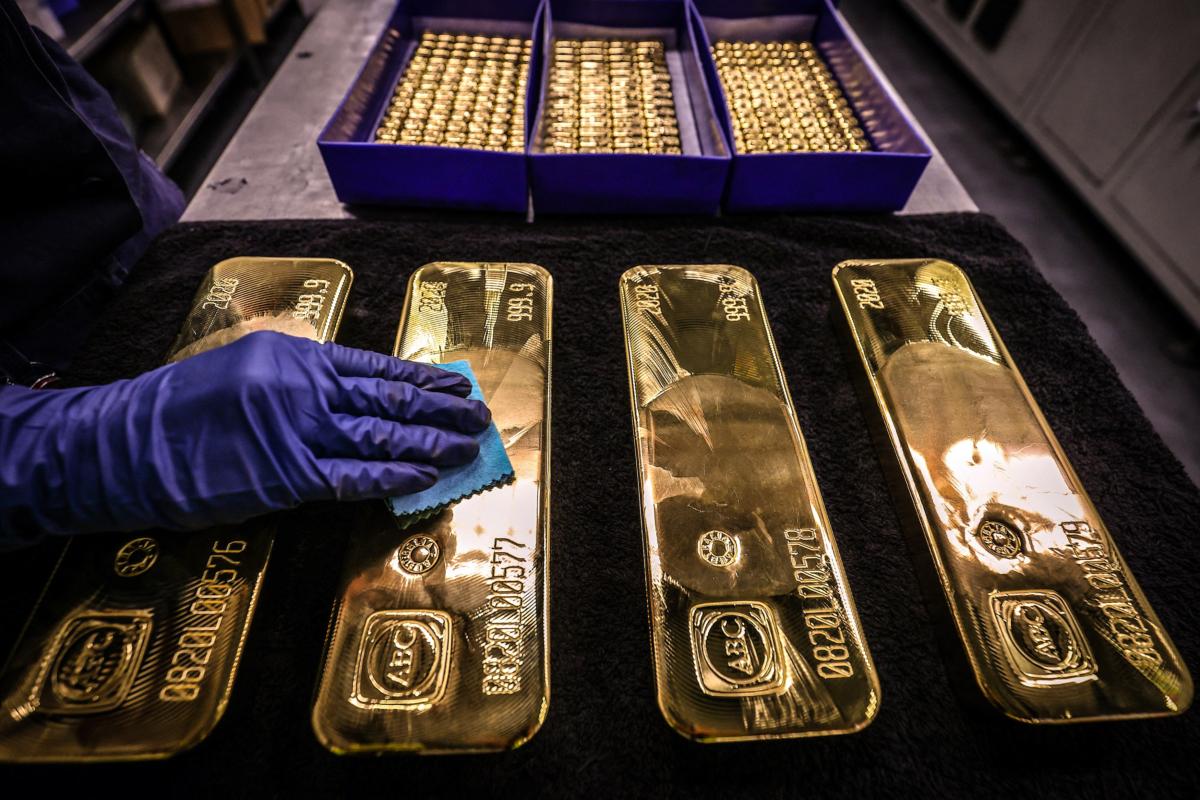 A worker polishes gold bullion bars at the ABC Refinery in Sydney on Aug. 5, 2020. Gold prices hit $2,000 an ounce on markets for the first time on Aug. 4, 2020. (David Gray/AFP via Getty Images)