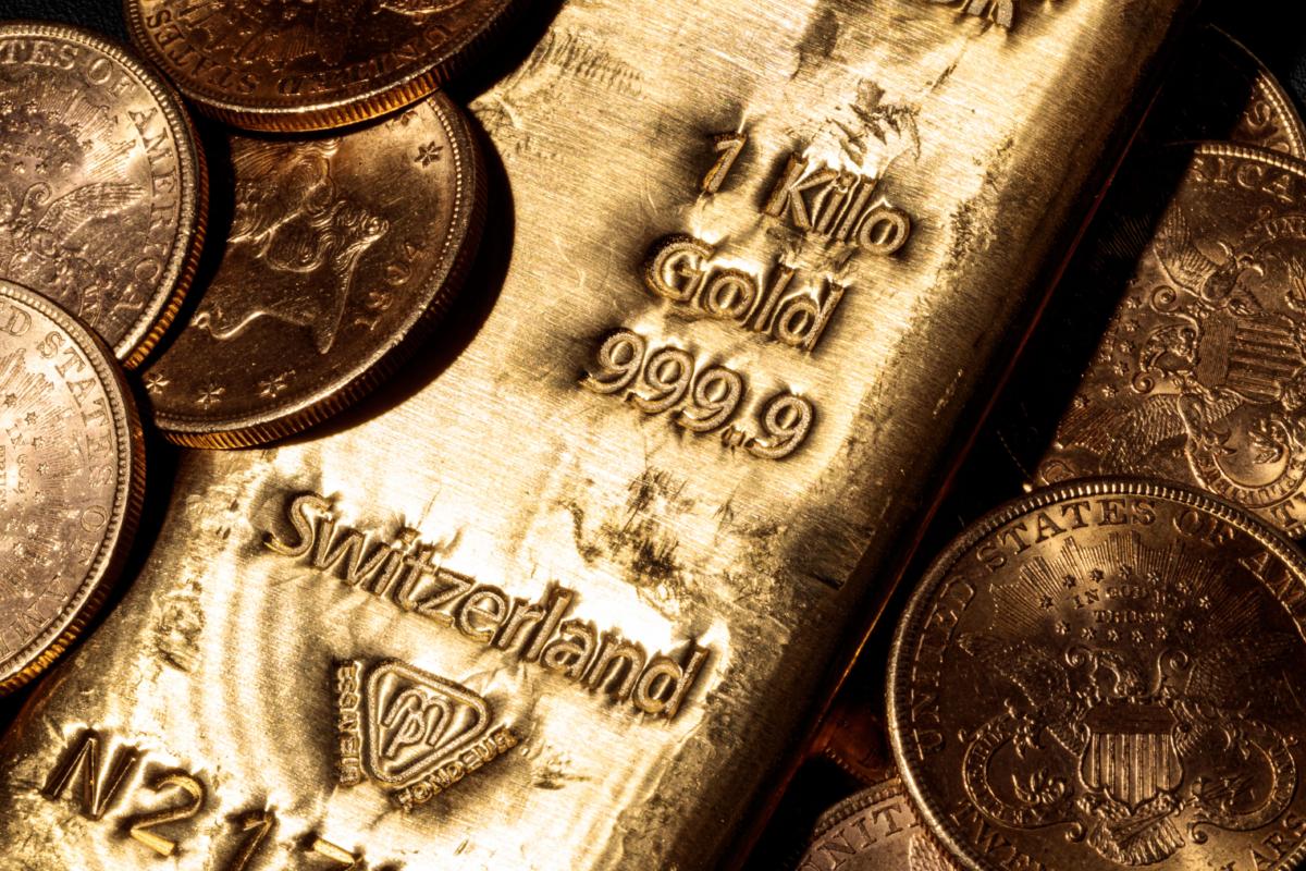 A one-kilo Swiss gold bar and gold U.S. dollars coins in Paris on Feb. 20, 2020. (JOEL SAGET/AFP via Getty Images)