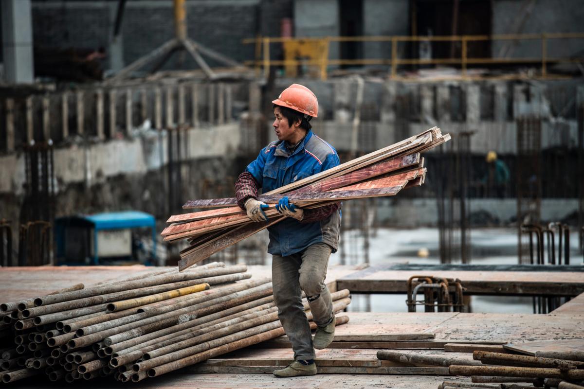 A man works at a construction site of a residential skyscraper in Shanghai on Nov. 29, 2016. (Johannes Eisele/AFP via Getty Images)