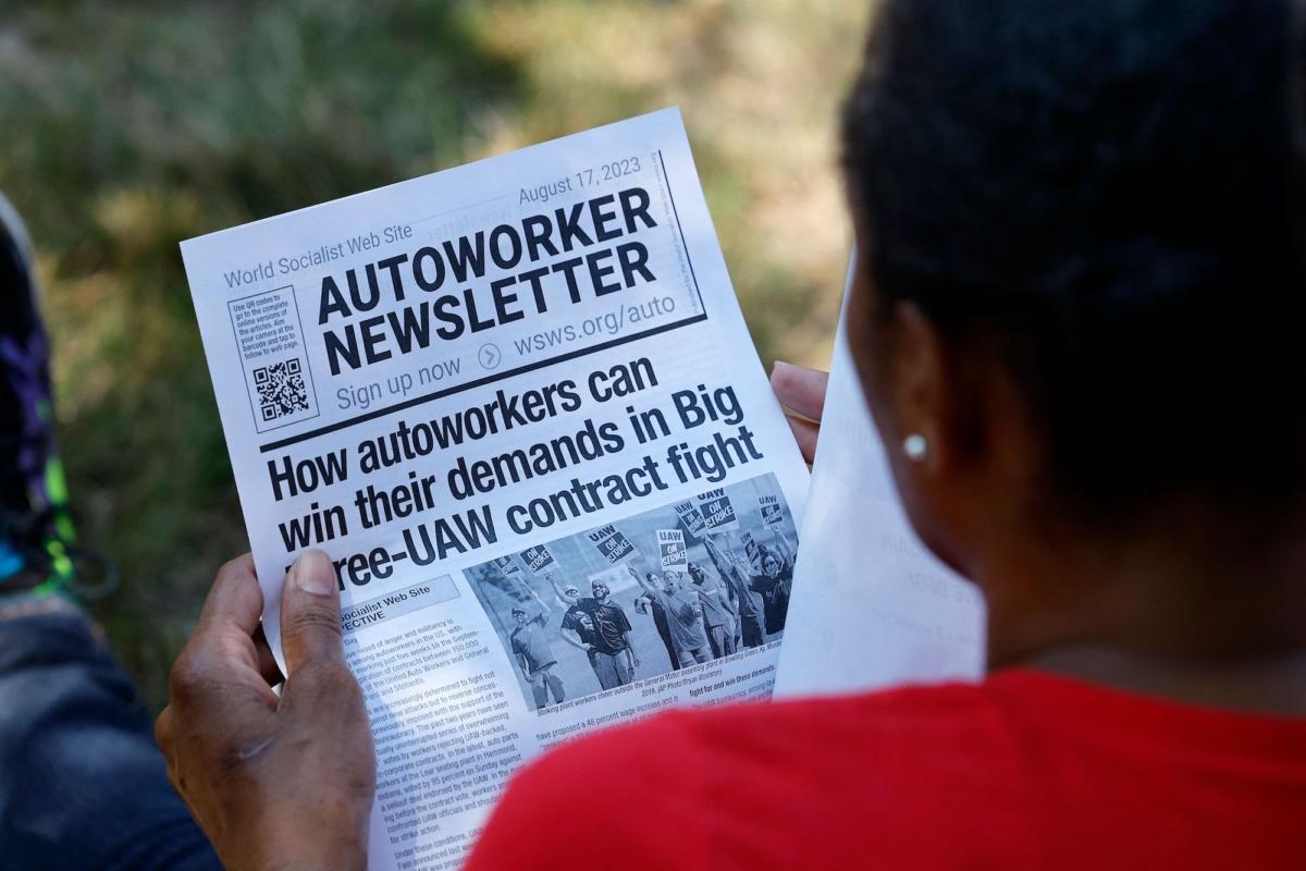 Fliers are passed out as United Automobile Workers (UAW) members gather at an event in Warren, Mich., on Aug. 20, 2023. (Jeff Kowalsky/AFP/Getty Images)