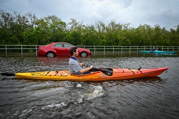 Residents use kayaks to travel on a flooded road in Tampa, Florida, on August 30, 2023, after Hurricane Idalia made landfall. (Miguel J. Rodriguez Carrillo / AFP via Getty Images)