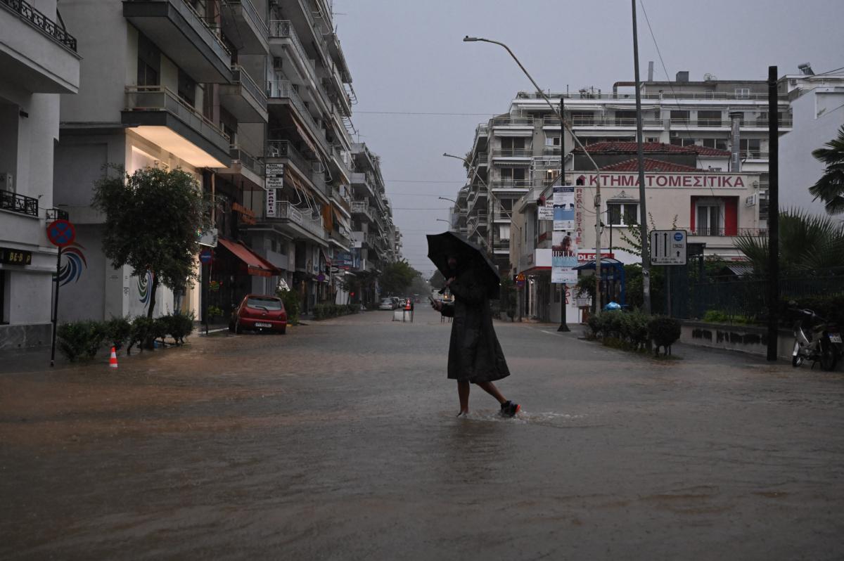 People walk on the flooded streets of the city of Volos, Greece, after it was hit by the severe weather front Daniel on Sept. 5, 2023. (Nephele Nomikou/SOOC/AFP via Getty Images)