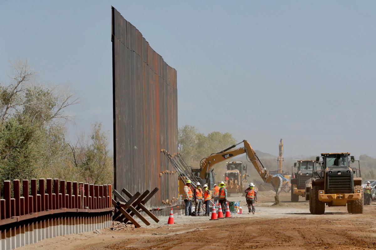 Government contractors erect a section of the Pentagon-funded border wall along the Colorado River, in Yuma, Ariz., on Sept. 10, 2019. (AP Photo/Matt York, File)