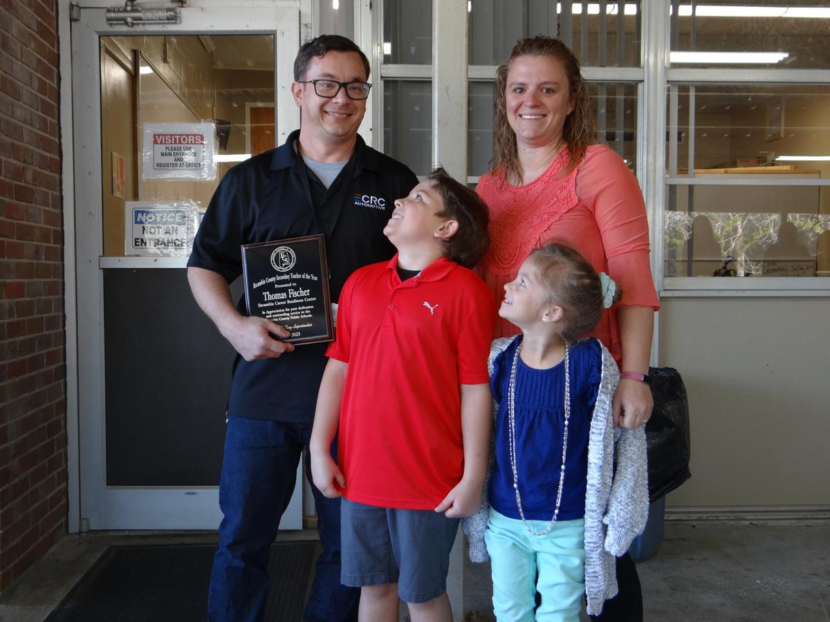Thomas Fischer with his wife, Carolyn, daughter, Sierra, and son, Simon, when he was named County Teacher of the Year in January. (Randy Tatano)