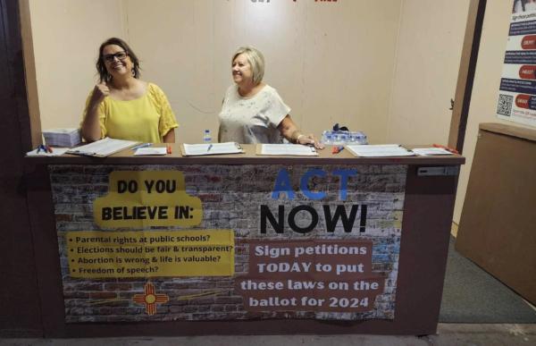 Linda Drake (left) and Sandra Reid (right) with the New Mexico Referendum Project gather signatures to repeal six progressive laws. (Courtesy of Victoria Derrer)