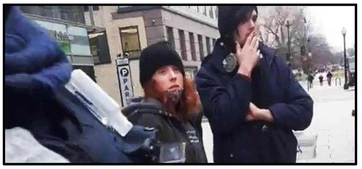 Antifa supporters Logan (aka Leslie) Grimes and Dempsey Mikula (right) look on while police search the vehicle in which they were riding on Jan. 6, 2021. (U.S. District Court/Screenshot via The Epoch Times)