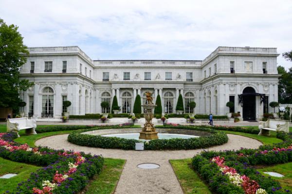 The grand façade of Rosecliff displays the H shape of the building and features arched windows across the center section. The entrance is graced with with reflecting pool. (Carol Ann Mossa/Shutterstock)