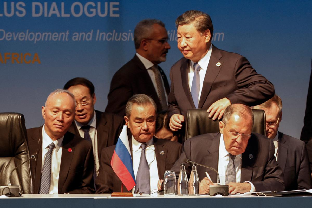 Chinese leader Xi Jinping (top R) walks past Russia's Foreign Minister Sergei Lavrov (R) and China's Foreign Minister Wang Yi (2nd R) during the 2023 BRICS Summit at the Sandton Convention Centre in Johannesburg on Aug. 24, 2023. (Marco Longari/AFP via Getty Images)